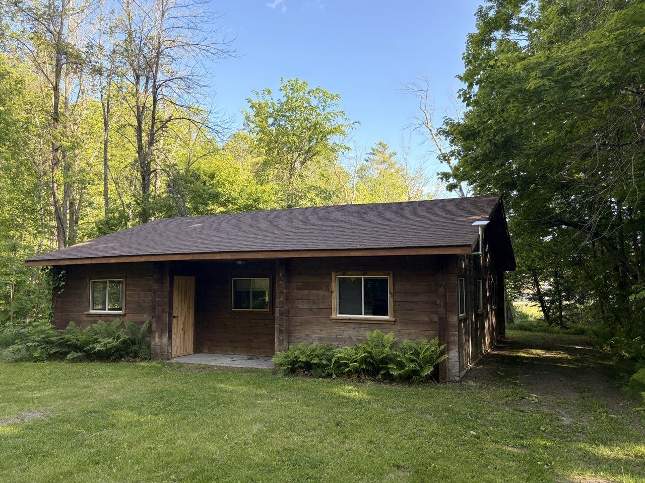 A cedar log cabin among the trees