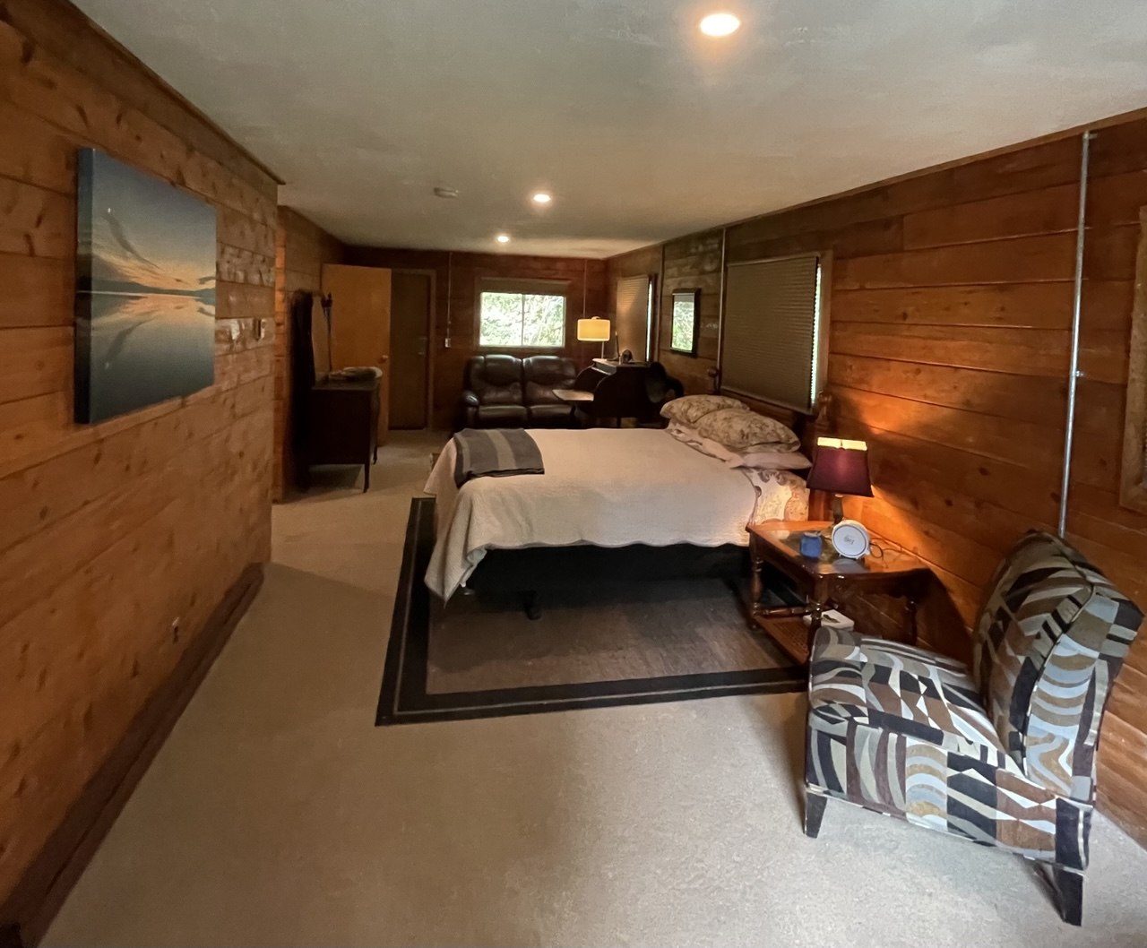 A cedar log cabin interior with beds and seating