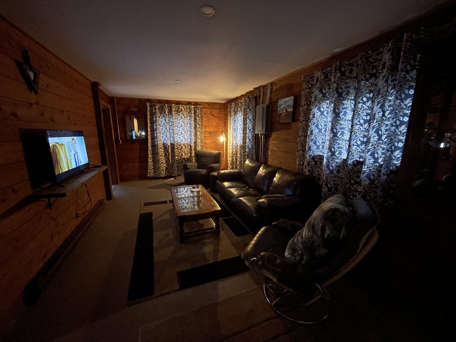 Lounge area with couch and large-screen TV